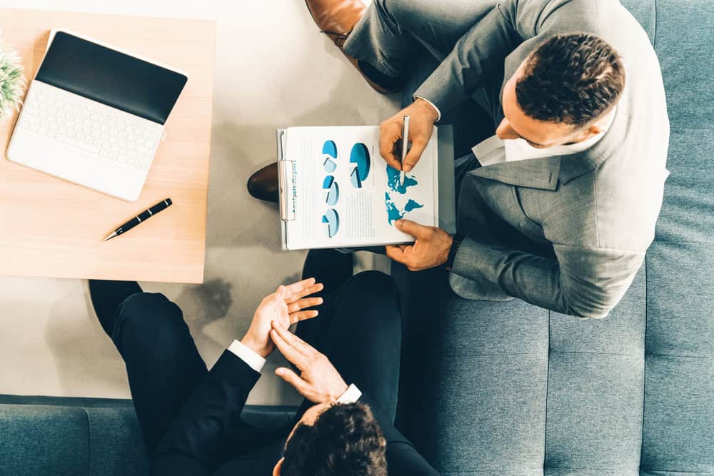 Businessman is in meeting discussion with another businessman partner in modern workplace office. People corporate business team concept. uds